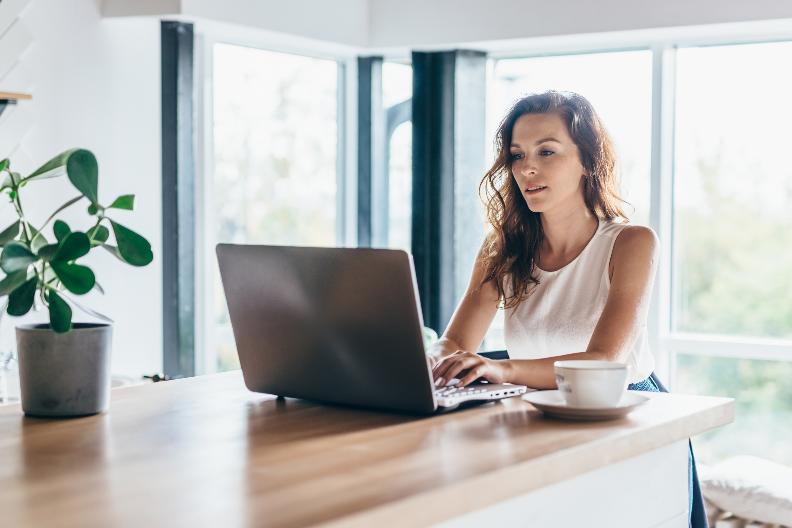 Woman,Using,Laptop,While,Sitting,At,Home