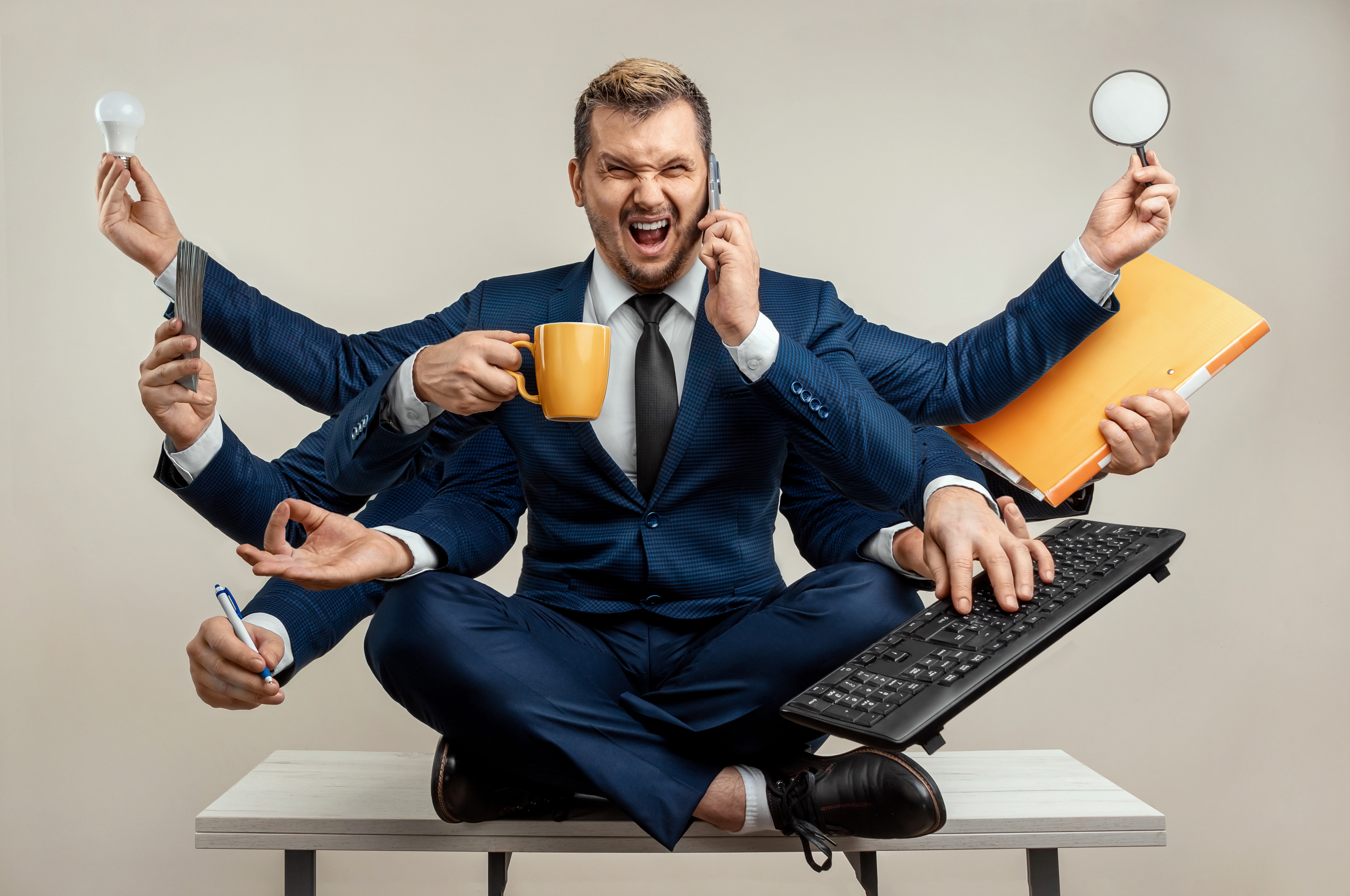 Businessman,With,Many,Hands,In,A,Suit.,Works,Simultaneously,With